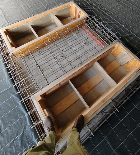 Reinforcement and concrete foundation for an in-ground scissor lift